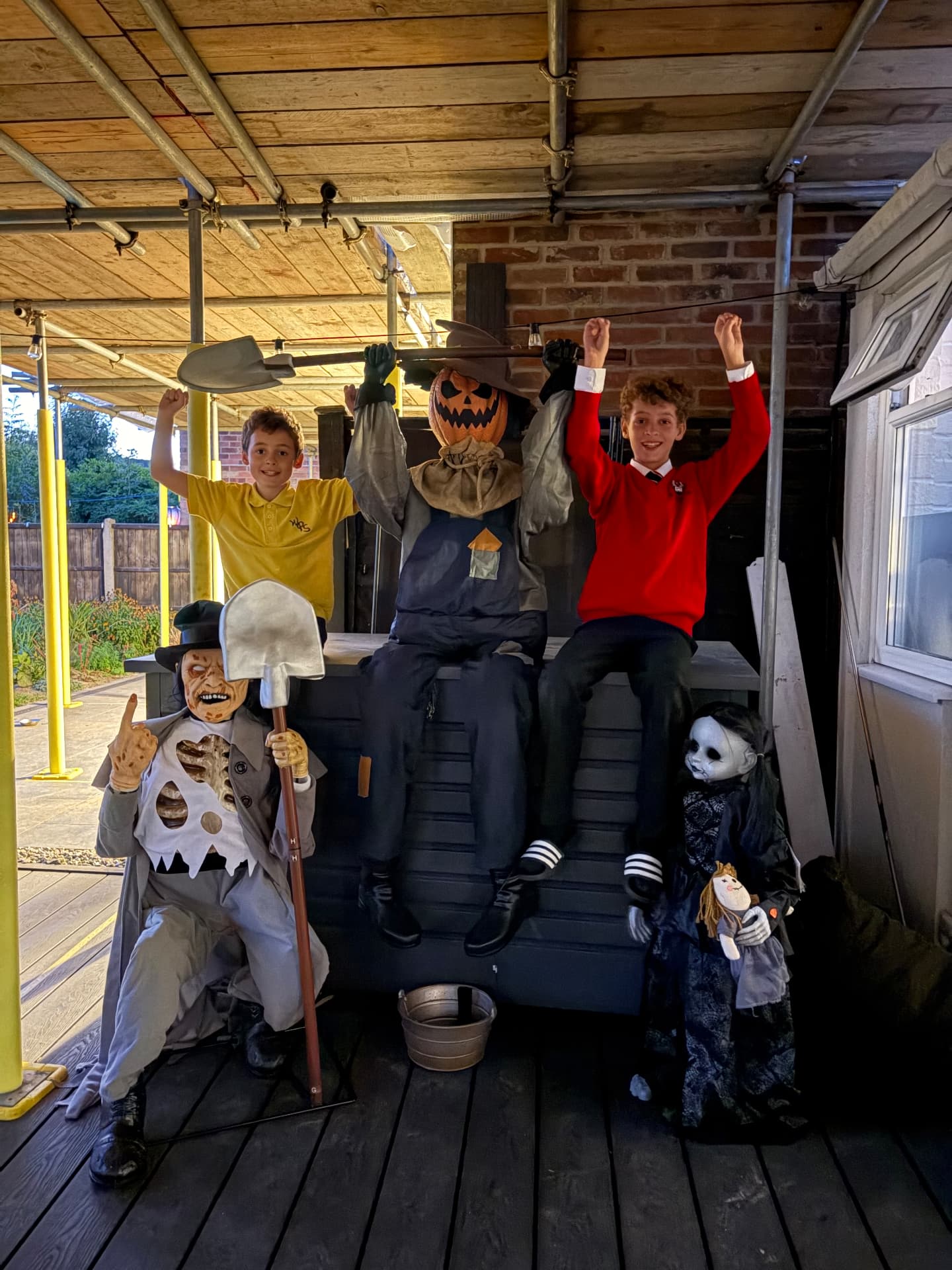 Dexter and Casper on the platform with the pumpkin scarecrow, the skeleton digger and the creepy doll
